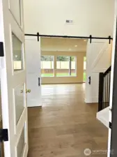 Enter into a home with refined finishes like these stately double barn doors.