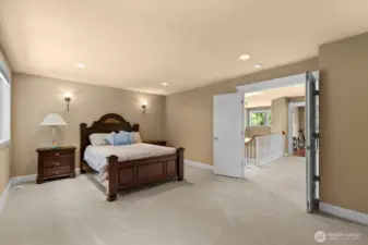 Primary Suite with double doors and space for sitting area walk in closet and a closet for him