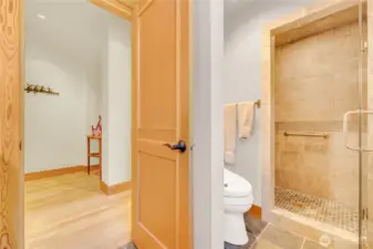 Main floor tile bathroom with glass-enclosed shower.