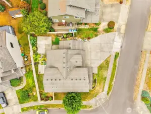 Aerial view of the lot, showing plenty of overflow parking, fully fenced back yard and easy care tile roof.