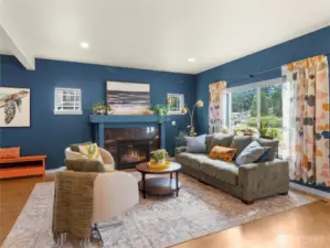 Family room with gas fireplace with granite surround.