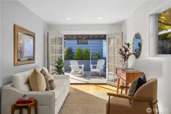 Great room off of the kitchen with french doors opening to backyard