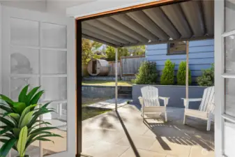 New patio and terraced backyard with sauna and detached garage accessed through alley with additional parking space