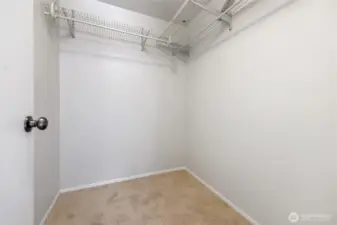 Primary bedroom walk in closet