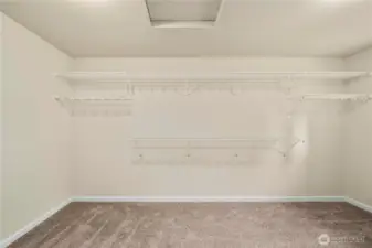Primary bedroom walk in closet.