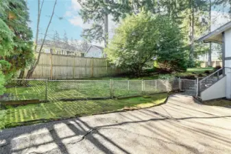 Fully fenced, level & sunny backyard.