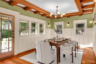 Formal dining room with exquisite craftsman details opens to covered patio