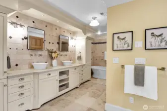 Stone countertops and tile flooring enhance the 5-piece primary bathroom