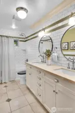 One of two full bathrooms in the hallway of the upper level. This bathroom offers dual vanities and a jetted tub