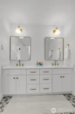 primary en-suite featuring a spacious dual-sink quartz vanity, warm brass fixtures, custom cabinetry, and designer lighting—delivering a spa-like retreat with elevated finishes