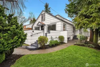 Front yard on SW corner with sidewalk extending to the backyard.