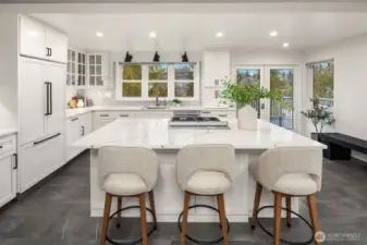 Looking east through kitchen to outside deck. Beautiful remodel. Seating right at the large island.