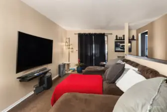 Living room  with enclosed sunporch beyond curtains