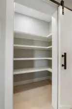 Built in shelves in the walk-in pantry just off the kitchen w/ barn door