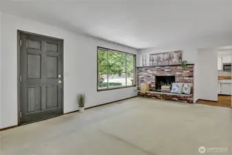 Spacious living room with wood burning brick fireplace