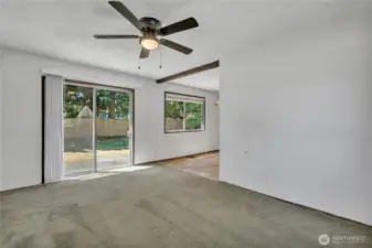 Sliding glass door from the family room leads into the large, level backyard