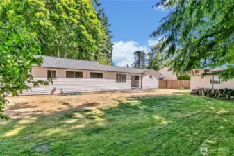 Large level backyard with mature trees