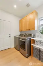 Utility / Mud Room.  A cushioned bench and storage cabinets are to the left.
