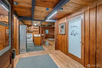 Step off the big covered porch and into a spacious entry that sets the tone. There’s room for a desk or reading nook, a “pantry” door that’s really the laundry (surprise!), and a peek straight through to the kitchen.