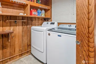 Open the door marked pantry and surprise—it’s the laundry room. Newer washer and dryer, storage space, plus the furnace and hot water tank all live here, neatly tucked away behind their not-so-secret disguise.