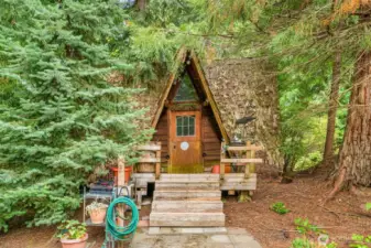 From the outside, it’s all storybook charm—a crooked roofline, mossy patina, and the kind of whimsy that looks plucked from a children’s book. Inside, it surprises with storage galore, though it’s best admired from afar. The shed is slowly returning to the earth, sloping and weathered, and not available for showings without the listing agent.