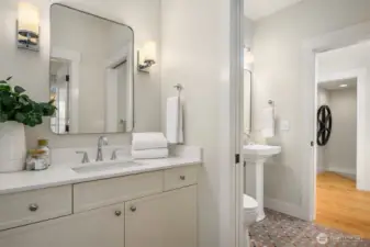 Custom painted cabinetry and pocket door that separates the bath spaces.