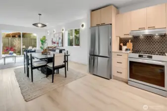 Bright, modern kitchen with soft close cabinets, SS appliances finish a minimalist design.