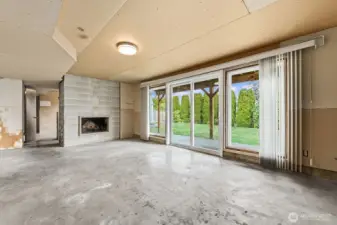 Large living space with wood fireplace ready to be finished