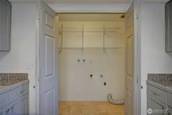 Laundry hookups with built in shelving.
