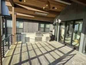 Custom outdoor kitchen with grill, sink and cabinets