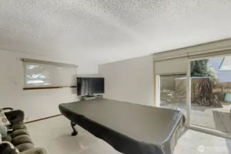 The bonus room invites in the light with windows and a newer slider out to the back yard patio.