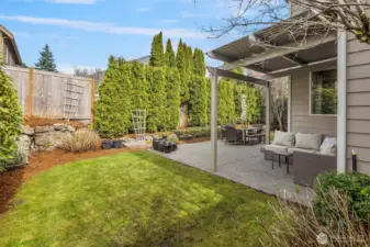 The side yard lawn and garden area, and a lovely pergola over the patio to enjoy
