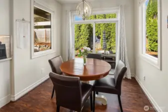 The cozy breakfast nook off the kitchen w/ slider doors leading out to the back patio