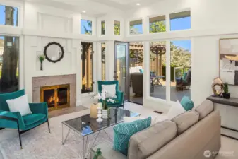 A gracious formal living room, hearth glowing softly, where fireside warmth spills onto the deck and sunlight lingers like a quiet invitation.