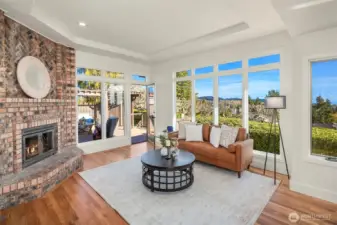 Bright family room or casual living area with new hardwood and fresh paint.