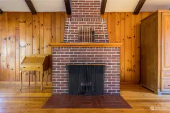 A handsome wood-burning brick fireplace an attractive focal point of the living area