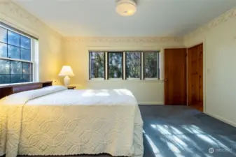 Primary Bedroom with original leaded glass windows. When open you can hear the soothing sounds of Stone Creek outside.
