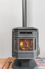 Pellet Stove in Dining Room. (currently inoperable - Seller thinks it needs a new auger motor - fire is image only).