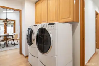 The laundry area, complete with a utility sink and generous storage, makes daily chores a breeze, with a full-size washer and dryer at your service.