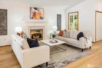 The elegant gas fireplace, framed by a wood mantle and millwork, adds warmth and charm.