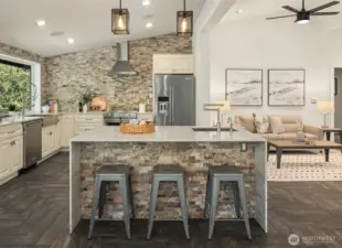 Island kitchen with waterfalled marble counters and stacked stone details.