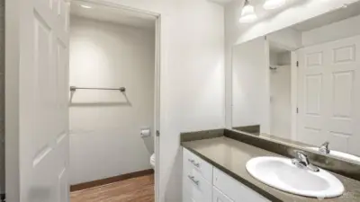 Updated vanity offers an abundance of storage and is separated from the water closet where you'll find the walk-in shower.