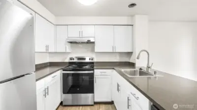 White shaker cabinetry, sleek countertops, plenty of storage & all appliances stay.