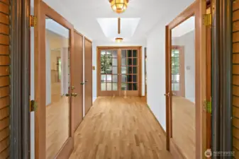 Double door front entry with French doors to the living room in the background.