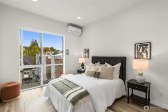 Enjoy abundant natural light and a peaceful view in this spacious, inviting bedroom.