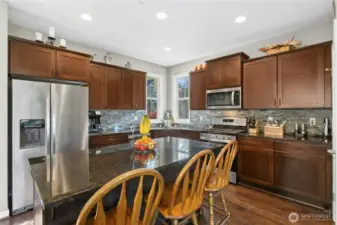 Kitchen:  A spacious, inviting kitchen that blends beauty and practicality. Rich wood cabinetry pairs perfectly with granite countertops and stainless steel appliances, while the large island offers plenty of space for prep, casual dining, or conversation. Bright windows bring in natural light, creating an easy, welcoming atmosphere.