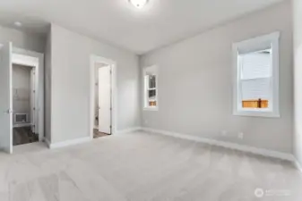 ***Not actual home*** Primary bedroom with lots of light