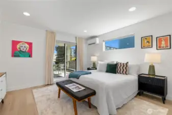 Spacious primary suite featuring a custom walk-in closet, a large covered deck, and a luxurious en-suite bathroom.