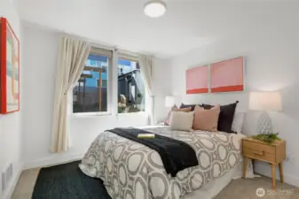 One of two guest suites on the lower level featuring a large closet and custom window treatments from The Shade Store, with Shade Store treatments throughout the home.