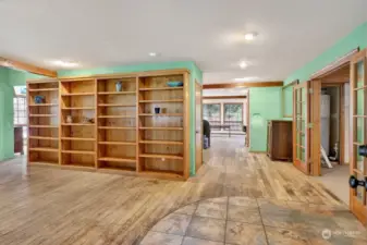 From the front entrance, the Library/living room or perhaps a dining area on the left, view toward kitchen, great room on the right.